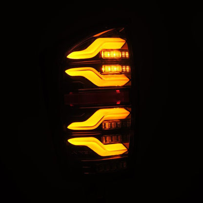 AlphaRex 16-21 Toyota Tacoma LUXX LED Taillights Alpha Blk w/Activ Light/Seq Signal - B2B Diesel & Gas Service
