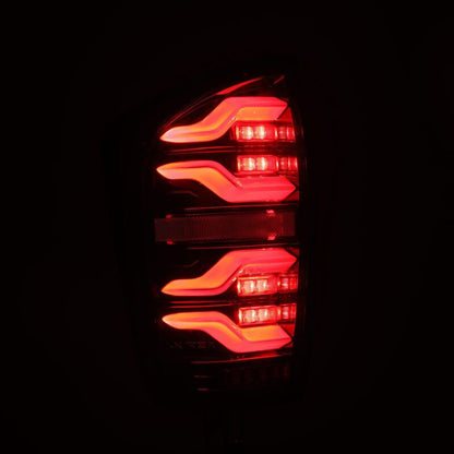 AlphaRex 16-21 Toyota Tacoma LUXX LED Taillights Alpha Blk w/Activ Light/Seq Signal - B2B Diesel & Gas Service